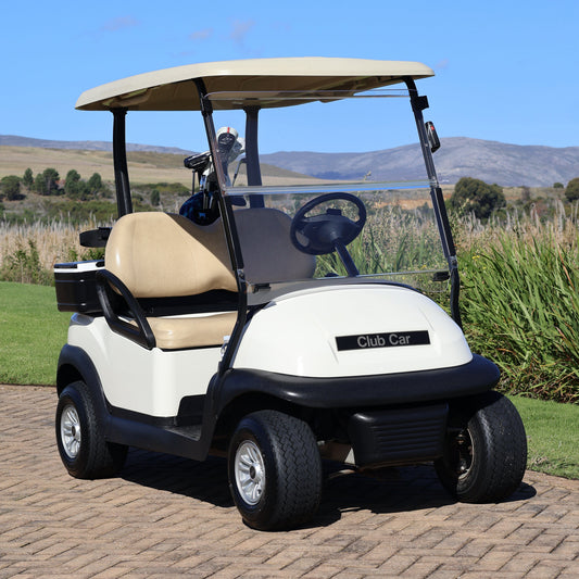 Golf cart on a golf course with a clear blue sky