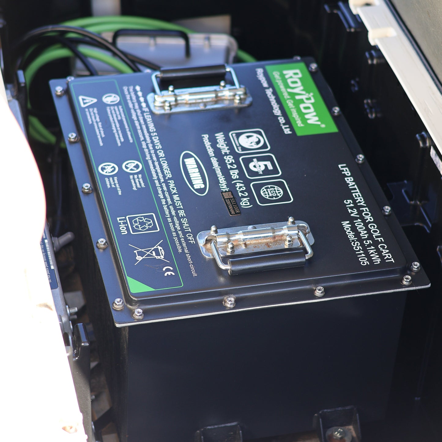 Close-up of electronic device with a screen displaying text and logos